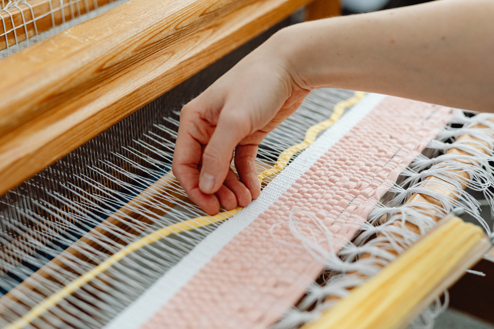 A Person Weaving Cotton Thread